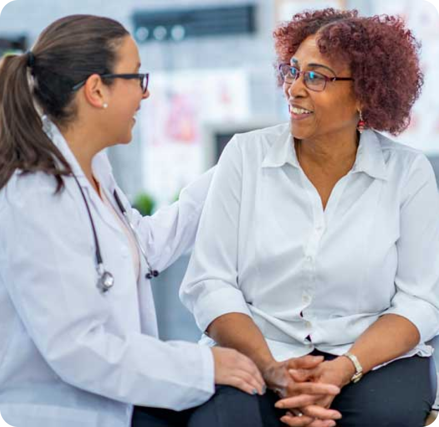 Doctor discussing and smilling with a patient.